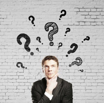 businessman thinking with question mark and brick wall